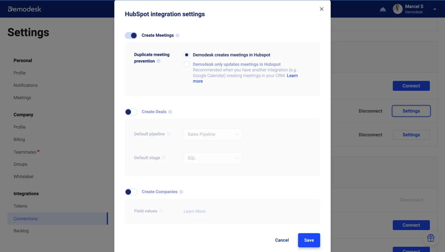HubSpot integration settings dialog with Create Meetings enabled and Demodesk creates meetings in HubSpot selected